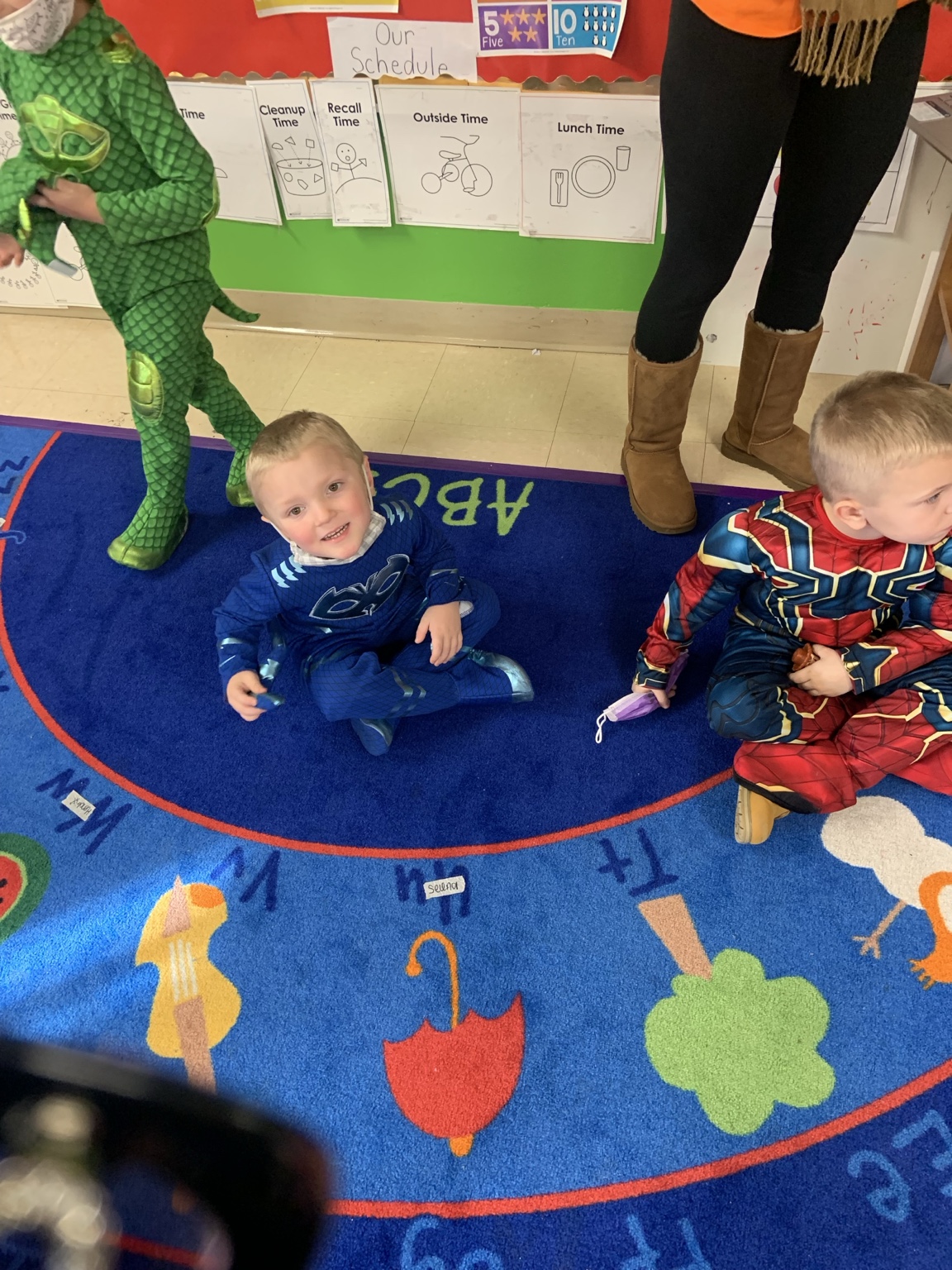 Children in colorful costumes sitting together in their classroom
